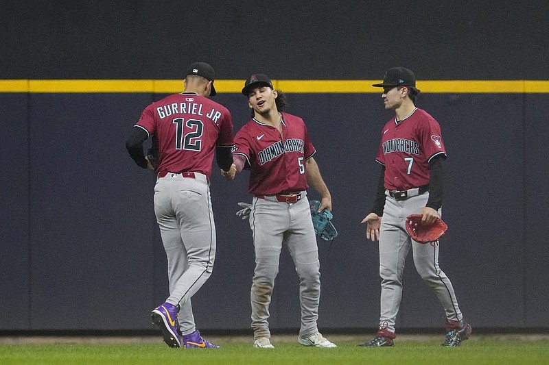 Aug 27, 2025; Milwaukee, Wisconsin, USA; Arizona Diamondbacks outfielder Arizona Diamondbacks outfielder Alek Thomas (5) and outfielder Corbin Carroll (7) celebrate a win over the Milwaukee Brewers at American Family Field. Mandatory Credit: Michael McLoone-Imagn Images
