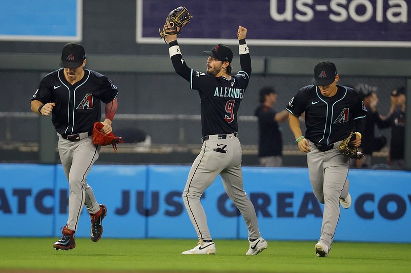 Sep 13, 2025; Minneapolis, Minnesota, USA; Arizona Diamondbacks right fielder Corbin Carroll (7) and left fielder Blaze Alexander (9) and center fielder Jorge Barrosa (1) celebrate the win over the Minnesota Twins after 10 innings at Target Field. Mandatory Credit: Bruce Kluckhohn-Imagn Images