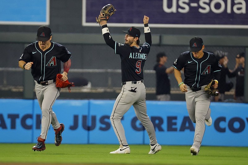 Sep 13, 2025; Minneapolis, Minnesota, USA; Arizona Diamondbacks right fielder Corbin Carroll (7) and left fielder Blaze Alexander (9) and center fielder Jorge Barrosa (1) celebrate the win over the Minnesota Twins after 10 innings at Target Field. Mandatory Credit: Bruce Kluckhohn-Imagn Images