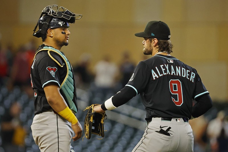 Sep 13, 2025; Minneapolis, Minnesota, USA; Arizona Diamondbacks catcher Gabriel Moreno (14) and left fielder Blaze Alexander (9) celebrate the win over the Minnesota Twins after 10 innings at Target Field. Mandatory Credit: Bruce Kluckhohn-Imagn Images