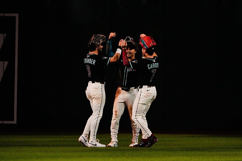 Sep 6, 2025; Phoenix, Arizona, USA; The outfielders ( Blaze Alexander (9), Alek Thomas (5) and Corbin Carroll (7) celebrate the win over the Boston Red Sox at Chase Field. Mandatory Credit: Arianna Grainey-Imagn Images