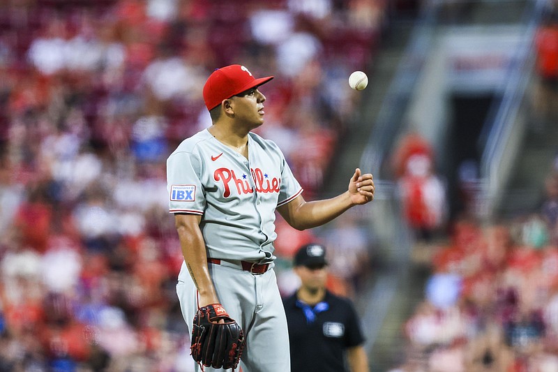 Aug 12, 2025; Cincinnati, Ohio, USA; Philadelphia Phillies starting pitcher Ranger Suarez (55) tosses a ball during a stop in play in the sixth inning against the Cincinnati Reds at Great American Ball Park. Mandatory Credit: Katie Stratman-Imagn Images