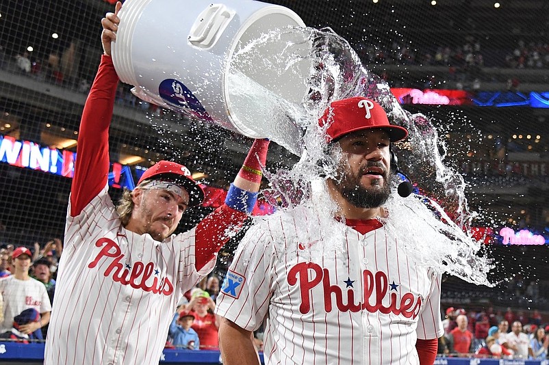 Sep 9, 2025; Philadelphia, Pennsylvania, USA; Philadelphia Phillies outfielder Kyle Schwarber (12) has water dumped on him by second base Bryson Stott (5) after win against the New York Mets at Citizens Bank Park. Mandatory Credit: Eric Hartline-Imagn Images