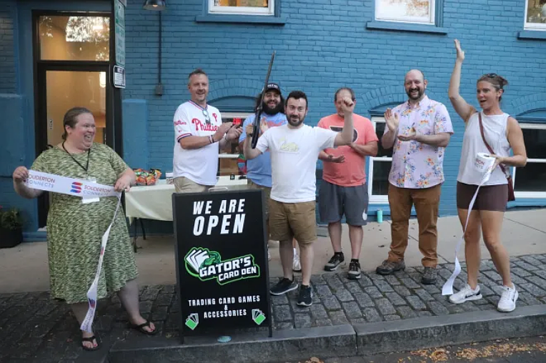 Jarrett Gellman cuts the ribbon at the September 19 grand opening ceremony of Gator’s Card Den in Souderton. (John Worthington – MediaNews Group)