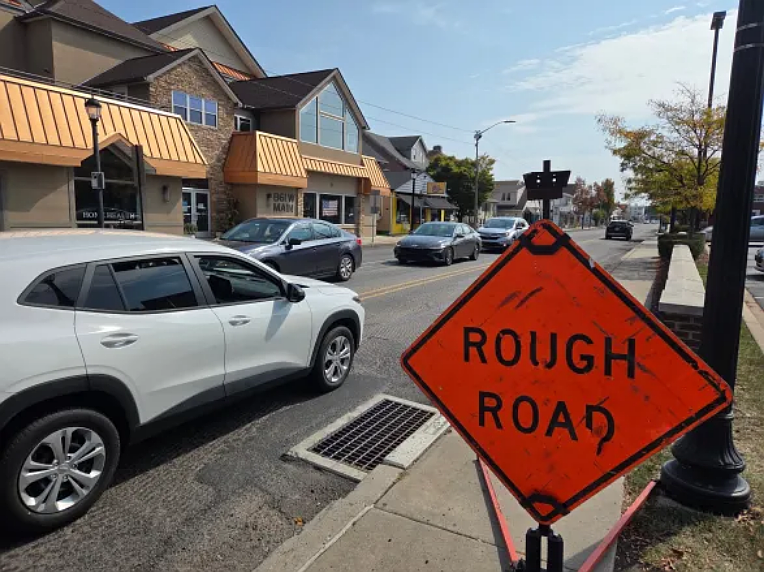 Drivers head east on Main Street past a sign reading “Rough road” in Lansdale on Tuesday, Sept. 23, 2025.