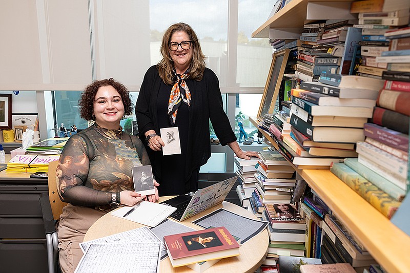 Stockton junior Zonja Kaja of Egg Harbor Township holds a portrait of American author Catharine Maria Sedgwick with Professor of Literature Deborah Gussman.