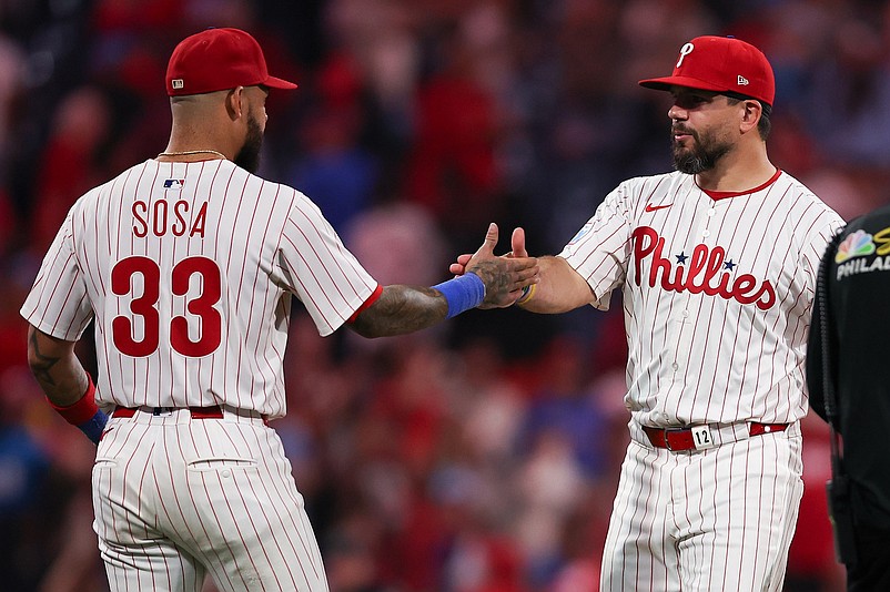 Sep 24, 2025; Philadelphia, Pennsylvania, USA; Philadelphia Phillies short stop Edmundo Sosa (33) and outfielder Kyle Schwarber (12) celebrate a victory against the Miami Marlins at Citizens Bank Park. Mandatory Credit: Bill Streicher-Imagn Images