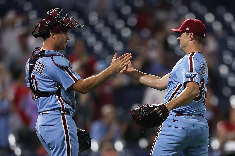 Sep 25, 2025; Philadelphia, Pennsylvania, USA; Philadelphia Phillies pitcher David Robertson (30) and catcher J.T. Realmuto (10) shake hands after a win against the Miami Marlins at Citizens Bank Park. Mandatory Credit: Bill Streicher-Imagn Images