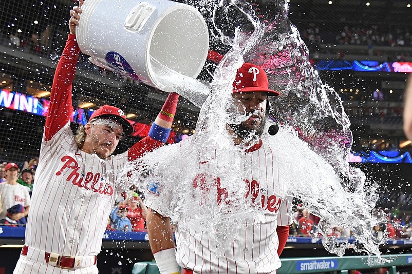 Sep 9, 2025; Philadelphia, Pennsylvania, USA; Philadelphia Phillies outfielder Kyle Schwarber (12) has water dumped on him by second base Bryson Stott (5) after win against the New York Mets at Citizens Bank Park. Mandatory Credit: Eric Hartline-Imagn Images