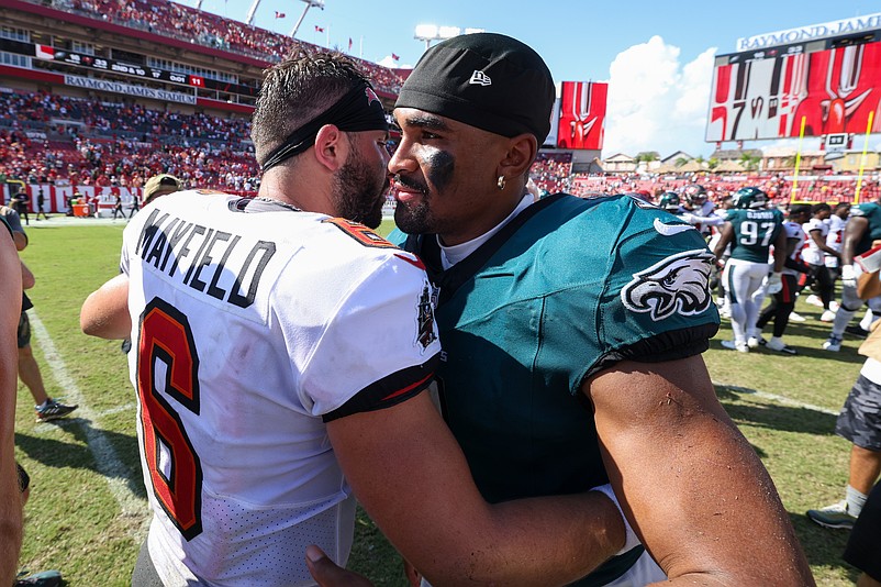Sep 29, 2024; Tampa, Florida, USA; Philadelphia Eagles quarterback Jalen Hurts (1) greets Tampa Bay Buccaneers quarterback Baker Mayfield (6) after a game at Raymond James Stadium. Mandatory Credit: Nathan Ray Seebeck-Imagn Images