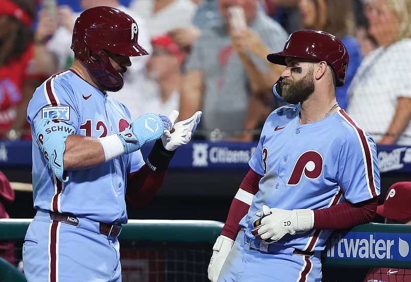 Sep 11, 2025; Philadelphia, Pennsylvania, USA; Philadelphia Phillies first base Bryce Harper (3) and outfielder Kyle Schwarber (12) talk during a New York Mets pitching change in the sixth inning at Citizens Bank Park. Mandatory Credit: Bill Streicher-Imagn Images