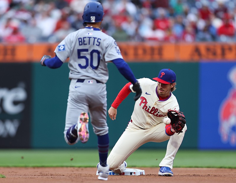 Apr 5, 2025; Philadelphia, Pennsylvania, USA; Philadelphia Phillies second base Bryson Stott (5) tags out Los Angeles Dodgers shortstop Mookie Betts (50) during the first inning at Citizens Bank Park. Mandatory Credit: Bill Streicher-Imagn Images