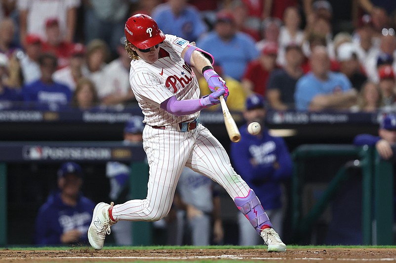 Oct 4, 2025; Philadelphia, Pennsylvania, USA; Philadelphia Phillies left fielder Harrison Bader (2) hits an RBI sacrifice fly against the Los Angeles Dodgers in the second inning during game one of the NLDS round for the 2025 MLB playoffs at Citizens Bank Park. Mandatory Credit: Bill Streicher-Imagn Images