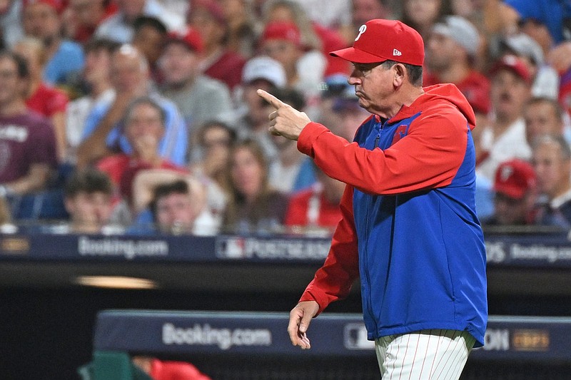 Oct 4, 2025; Philadelphia, Pennsylvania, USA; Philadelphia Phillies manager Rob Thomson (49) signals to the bullpen during the seventh inning against the Los Angeles Dodgers during game one of the NLDS round for the 2025 MLB playoffs at Citizens Bank Park. Mandatory Credit: Eric Hartline-Imagn Images
