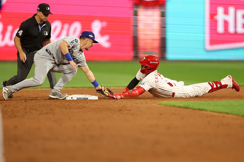 Oct 6, 2025; Philadelphia, Pennsylvania, USA; Philadelphia Phillies right fielder Nick Castellanos (8) slides into second base safely against Los Angeles Dodgers second baseman Tommy Edman (25) in the ninth inning during game two of the NLDS round for the 2025 MLB playoffs at Citizens Bank Park. Mandatory Credit: Bill Streicher-Imagn Images