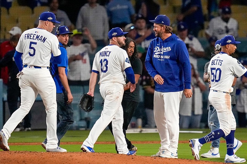 Newly retired Los Angeles Dodgers pitcher Clayton Kershaw celebrates the win after the ninth inning of the MLB National League Wild Card Game 1 between the Los Angeles Dodgers and the Cincinnati Reds at Dodger Stadium in Los Angeles on Tuesday, Sept. 30, 2025. The Dodgers won game 1 of the series, 10-5.