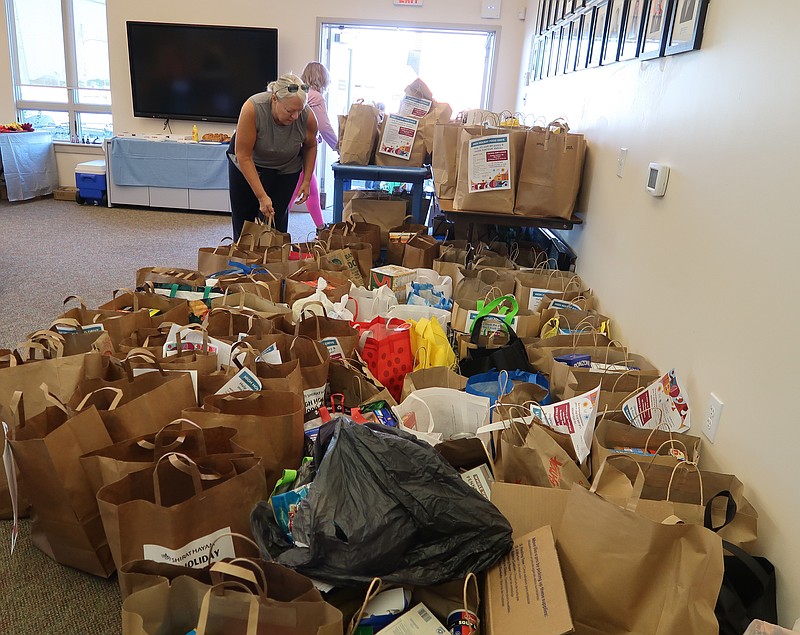 JFS/Volunteer Mindy Goldberg sorts through bags of non-perishable products donated to Jewish Family Service of Atlantic & Cape May Counties during the High Holidays Food Drive.