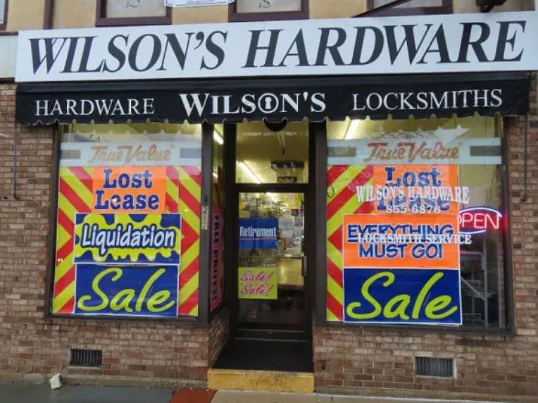 Liquidation sale signs are posted on the Main Street entrance to Wilson’s Hardware in Lansdale shortly ahead of its closing in Feb. 2022.