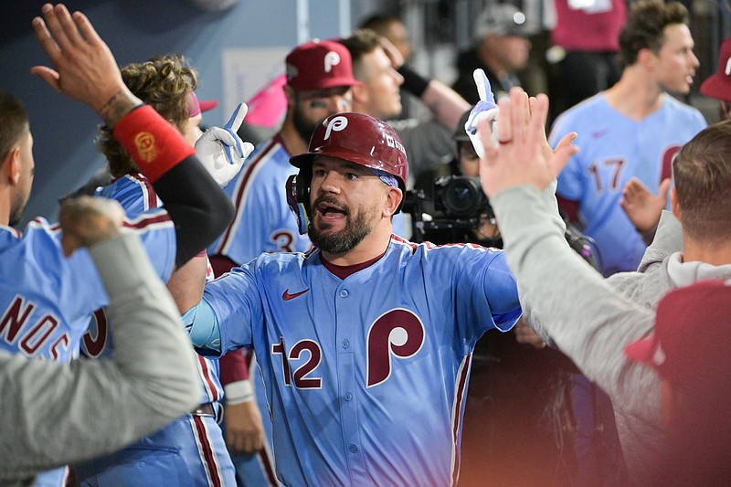 Oct 8, 2025; Los Angeles, California, USA; Philadelphia Phillies designated hitter Kyle Schwarber (12) celebrates in the dugout after hitting a solo home run during the fourth inning against the Los Angeles Dodgers during game three of the NLDS round for the 2025 MLB playoffs at Dodger Stadium. Mandatory Credit: Jayne Kamin-Oncea-Imagn Images
