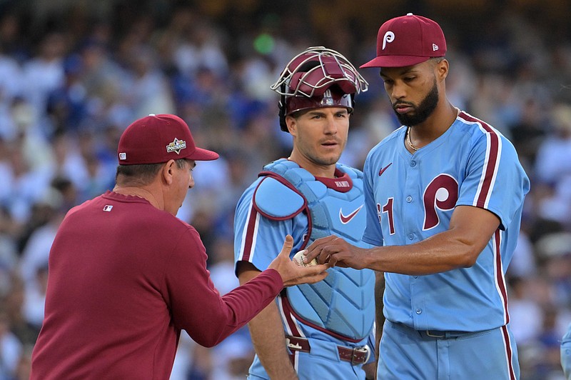 Oct 9, 2025; Los Angeles, California, USA; Philadelphia Phillies pitcher Cristopher Sanchez (61) is relieved by manager Rob Thomson (49) in the seventh inning against the Los Angeles Dodgers during game four of the NLDS round for the 2025 MLB playoffs at Dodger Stadium. Mandatory Credit: Jayne Kamin-Oncea-Imagn Images