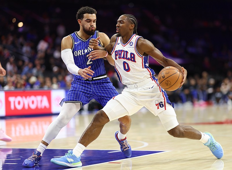 Oct 10, 2025; Philadelphia, Pennsylvania, USA; Philadelphia 76ers guard Tyrese Maxey (0) drives against Orlando Magic guard Tyus Jones (2) during the first quarter at Xfinity Mobile Arena. Mandatory Credit: Bill Streicher-Imagn Images