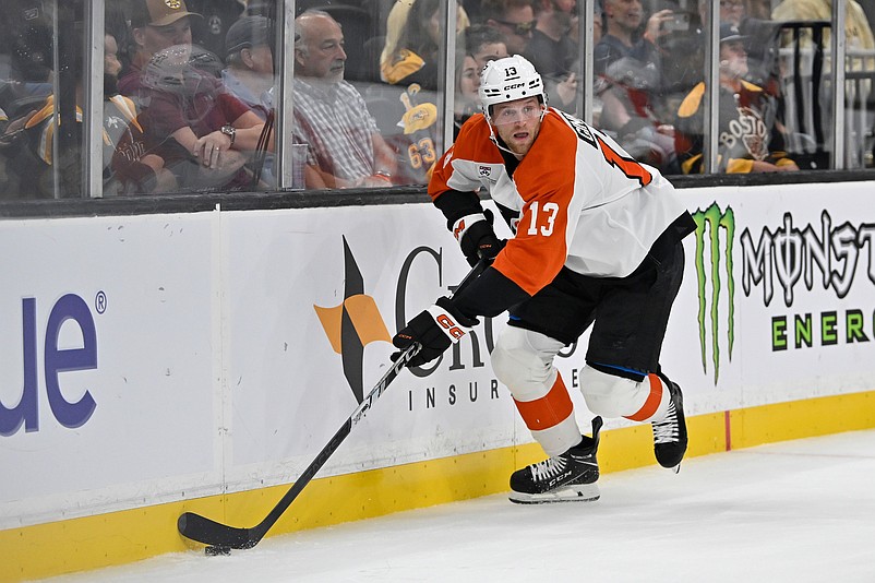 Sep 29, 2025; Boston, Massachusetts, USA;  Philadelphia Flyers defenseman Adam Ginning (13) plays the puck in the corner during the first period against the Boston Bruins at TD Garden. Mandatory Credit: Eric Canha-Imagn Images