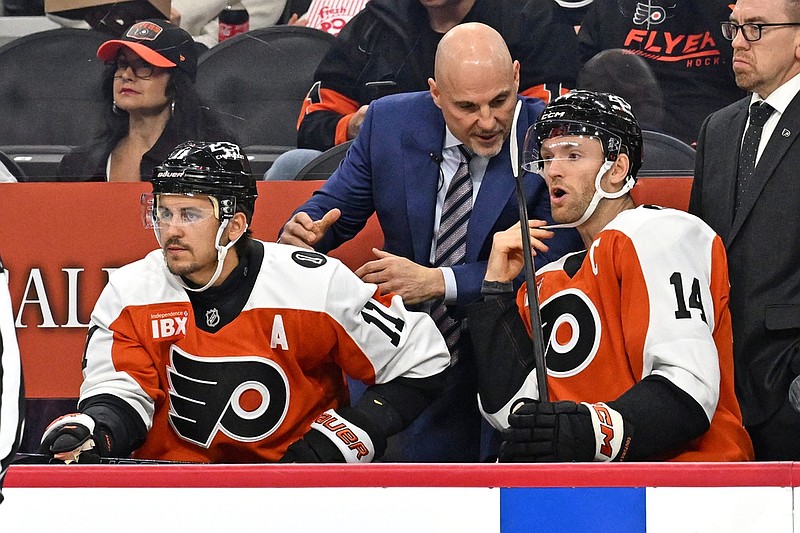 Oct 13, 2025; Philadelphia, Pennsylvania, USA; Philadelphia Flyers head coach Rick Tocchet talks with Philadelphia Flyers center Sean Couturier (14) and right wing Travis Konecny (11) against the Florida Panthers during the first period at Wells Fargo Center. Mandatory Credit: Eric Hartline-Imagn Images