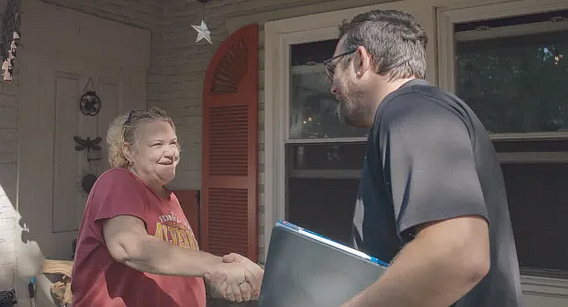 Teri Jensen-Sellers, left, greets James Bull, assistant sales manager, Bachman’s Roofing, as a crew arrived to replace the roof on Jensen-Seller’s Pottstown home. The company donated the roof for Jensen-Sellers, a breast cancer survivor, as part of Breast Cancer Awareness month.(Courtesy Bachman’s Roofing and Solar)