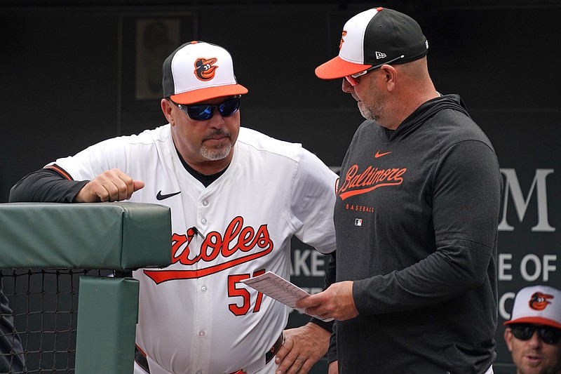 Apr 17, 2024; Baltimore, Maryland, USA; Baltimore Orioles coach Fredi Gonzalez (left) talks with manager Brandon Hyde (right) in the first inning against the Minnesota Twins at Oriole Park at Camden Yards. Mandatory Credit: Mitch Stringer-USA TODAY Sports