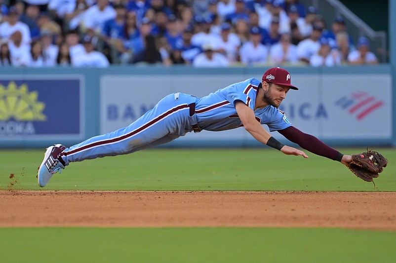 Oct 9, 2025; Los Angeles, California, USA; Philadelphia Phillies shortstop Trea Turner (7) fields a ground ball and throws to first for an out in the seventh inning against the Los Angeles Dodgers during game four of the NLDS round for the 2025 MLB playoffs at Dodger Stadium. Mandatory Credit: Jayne Kamin-Oncea-Imagn Images