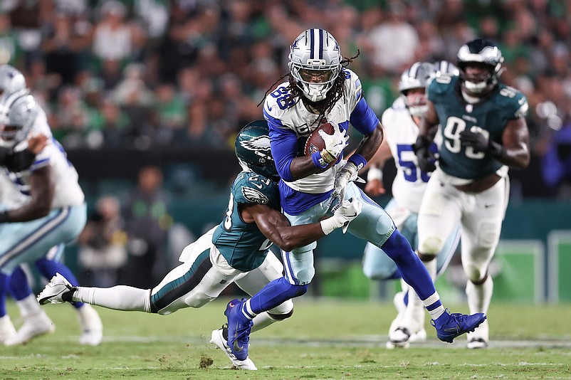 Sep 4, 2025; Philadelphia, Pennsylvania, USA; Philadelphia Eagles cornerback Jakorian Bennett (23) tackles Dallas Cowboys wide receiver CeeDee Lamb (88) during the second quarter of the game at Lincoln Financial Field. Mandatory Credit: Bill Streicher-Imagn Images