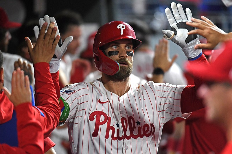 Aug 18, 2025; Philadelphia, Pennsylvania, USA;  Philadelphia Phillies first base Bryce Harper (3) celebrates in the dugout after hitting a three-run home run during the seventh inning against the Seattle Mariners at Citizens Bank Park. Mandatory Credit: Eric Hartline-Imagn Images