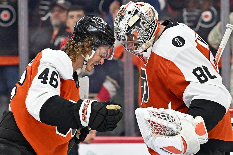 Oct 13, 2025; Philadelphia, Pennsylvania, USA; Philadelphia Flyers center Trevor Zegras (46) and goaltender Dan Vladar (80) celebrate win against the Florida Panthers at Wells Fargo Center. Mandatory Credit: Eric Hartline-Imagn Images
