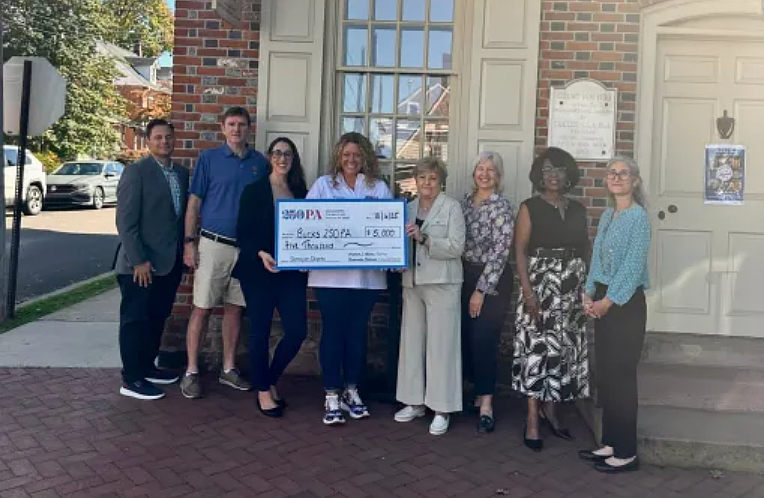 America250PA Executive Director Cassandra Coleman was joined in Newtown by members of the Bucks250PA Committee, Visit Bucks County, and the Office of Senator Steve Santarsiero to celebrate the funding award. (Courtesy of Bucks250PA)