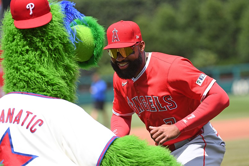 Jul 20, 2025; Philadelphia, Pennsylvania, USA; Los Angeles Angels outfielder Jo Adell (7) mixes it up with the Phillie Phanatic before game against the Philadelphia Phillies at Citizens Bank Park. Mandatory Credit: Eric Hartline-Imagn Images