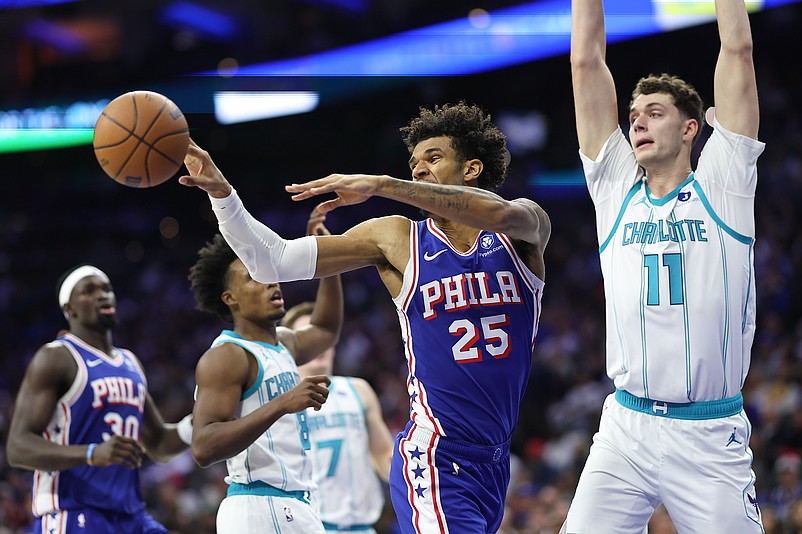 Oct 25, 2025; Philadelphia, Pennsylvania, USA; Philadelphia 76ers forward Dominick Barlow (25) passes the ball in front of Charlotte Hornets center Ryan Kalkbrenner (11) during the second quarter at Xfinity Mobile Arena. Mandatory Credit: Bill Streicher-Imagn Images