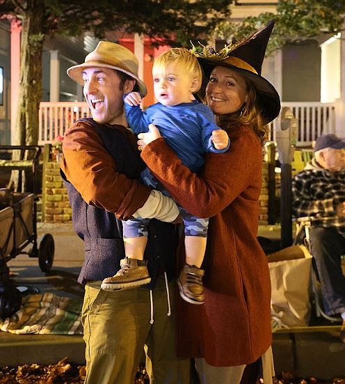 Jason and Ginny Plum enjoy the parade along with their 15-month-old son, Emery.