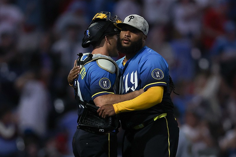 May 16, 2025; Philadelphia, Pennsylvania, USA; Philadelphia Phillies pitcher JosŽ Alvarado (46 and catcher J.T. Realmuto (10) hug after a victory against the Pittsburgh Pirates at Citizens Bank Park. Mandatory Credit: Bill Streicher-Imagn Images