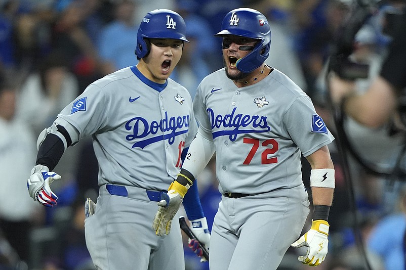 Nov 1, 2025; Toronto, Ontario, CAN; Los Angeles Dodgers second baseman Miguel Rojas (72) celebrates with two-way player Shohei Ohtani (17) after scoring against the Toronto Blue Jays in the ninth inning during game seven of the 2025 MLB World Series at Rogers Centre. Mandatory Credit: John E. Sokolowski-Imagn Images