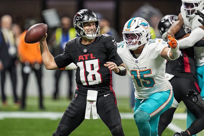 Oct 26, 2025; Atlanta, Georgia, USA; Atlanta Falcons quarterback Kirk Cousins (18) passes under pressure from Miami Dolphins linebacker Jaelan Phillips (15) during the first quarter at Mercedes-Benz Stadium. Mandatory Credit: Dale Zanine-Imagn Images