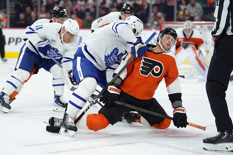 Nov 1, 2025; Philadelphia, Pennsylvania, USA; Philadelphia Flyers right wing Tyson Foerster (71) reacts against Toronto Maple Leafs center John Tavares (91) in the first period at Xfinity Mobile Arena. Mandatory Credit: Kyle Ross-Imagn Images