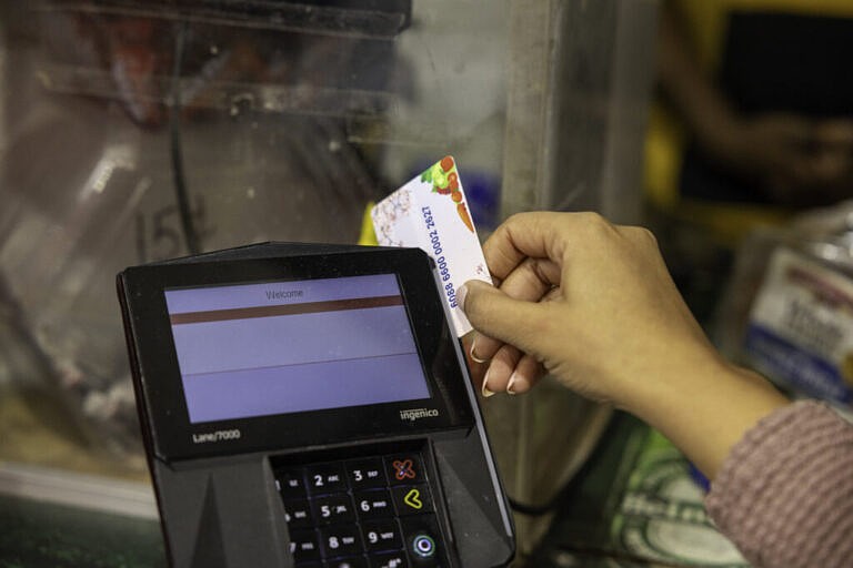 A shopper who receives SNAP benefits slides an EBT card at a checkout counter in a Washington, D.C., grocery store in December 2024. (Photo by U.S. Department of Agriculture)