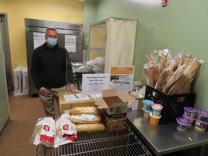 Volunteer Rick Fanciullacci stands at the entrance to the Manna Market, awaiting those shopping for groceries at Manna on Main Street in Lansdale on Tuesday Nov. 23 2021.