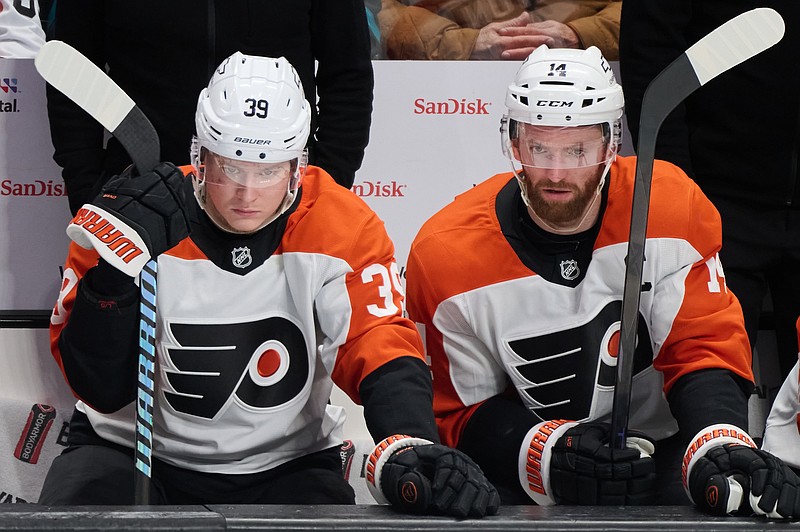 Dec 31, 2024; San Jose, California, USA; Philadelphia Flyers right wing Matvei Michkov (39) and Philadelphia Flyers center Sean Couturier (14) watch game play from the bench against the San Jose Sharks during the third period at SAP Center at San Jose. Mandatory Credit: Robert Edwards-Imagn Images