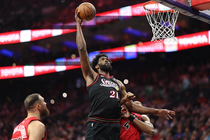 Nov 8, 2025; Philadelphia, Pennsylvania, USA; Philadelphia 76ers center Joel Embiid (21) drives for a shot against Toronto Raptors forward Scottie Barnes (4) during the second quarter at Xfinity Mobile Arena. Mandatory Credit: Bill Streicher-Imagn Images