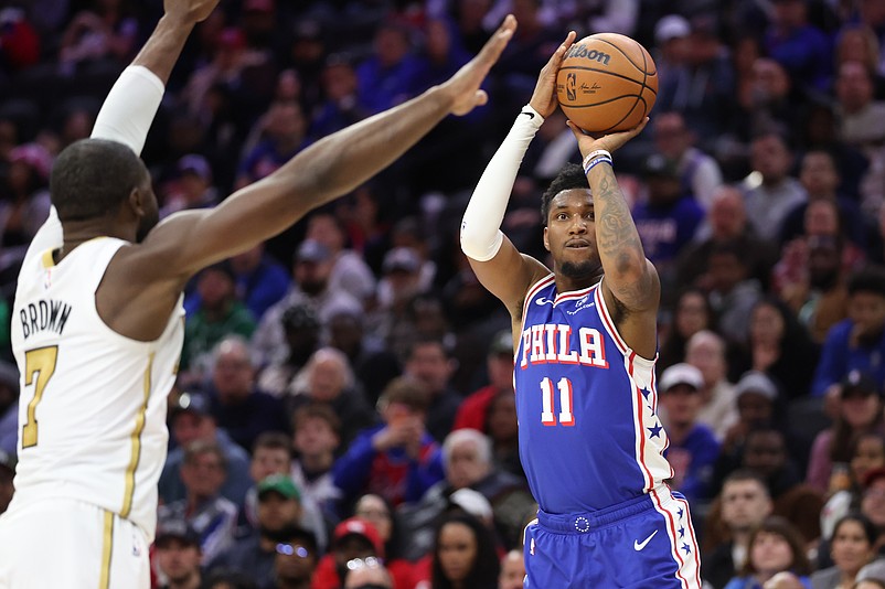 Nov 11, 2025; Philadelphia, Pennsylvania, USA; Philadelphia 76ers forward Justin Edwards (11) shoots in front of Boston Celtics guard Jaylen Brown (7) during the fourth quarter at Xfinity Mobile Arena. Mandatory Credit: Bill Streicher-Imagn Images