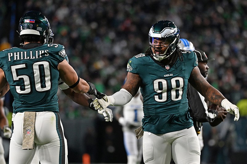 Nov 16, 2025; Philadelphia, Pennsylvania, USA;  Philadelphia Eagles defensive tackle Jalen Carter (98) celebrates a stop with linebacker Jaelan Phillips (50) against the Detroit Lions at Lincoln Financial Field. Mandatory Credit: Eric Hartline-Imagn Images