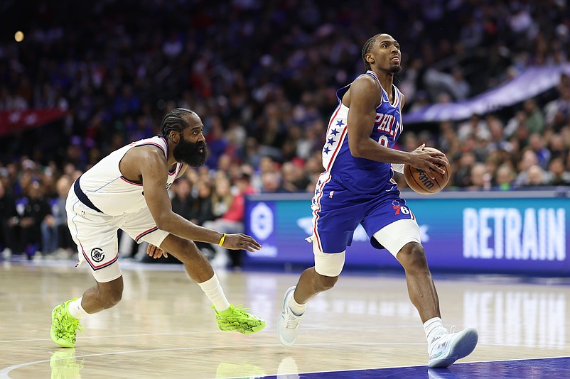 Nov 17, 2025; Philadelphia, Pennsylvania, USA; Philadelphia 76ers guard Tyrese Maxey (0) drives past LA Clippers guard James Harden (1) during the second quarter at Xfinity Mobile Arena. Mandatory Credit: Bill Streicher-Imagn Images