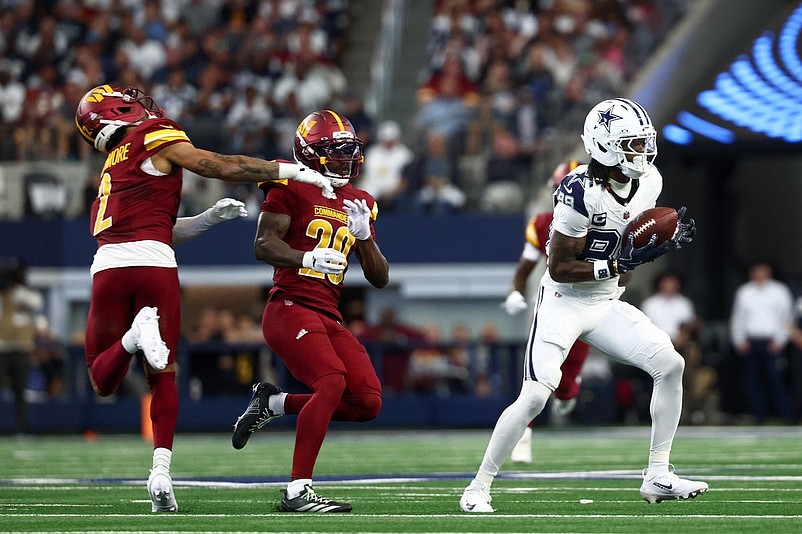 Oct 19, 2025; Arlington, Texas, USA; Dallas Cowboys wide receiver Ceedee Lamb (88) makes a reception as Washington Commanders safety Quan Martin (20) and cornerback Marshon Lattimore (2) collide during the first quarter of the game at AT&T Stadium. Lamb scored a touchdown on the play. Mandatory Credit: Kevin Jairaj-Imagn Images
