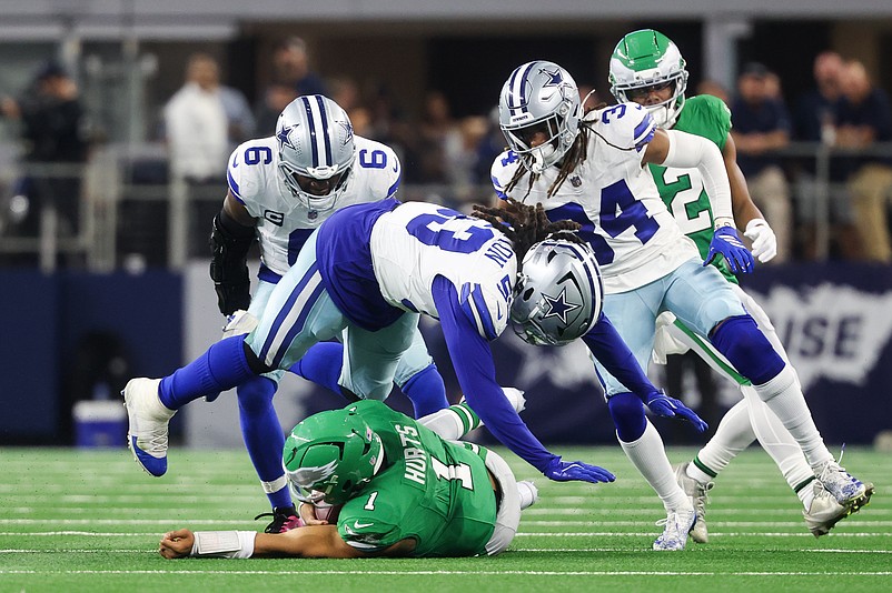 Nov 23, 2025; Arlington, Texas, USA; Philadelphia Eagles quarterback Jalen Hurts (1) slides with the ball in the third quarter against the Dallas Cowboys at AT&T Stadium. Mandatory Credit: Kevin Jairaj-Imagn Images